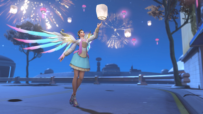 Mercy in a Lunar New Year skin lifting a lantern into the sky, with fireworks going off in the background.