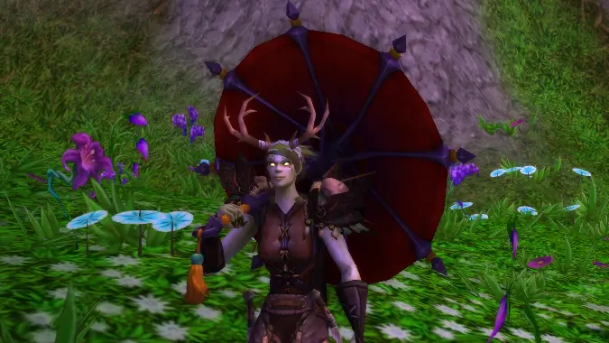 An undead in druid transmog shades herself with a Delicate Crimson Parasol.